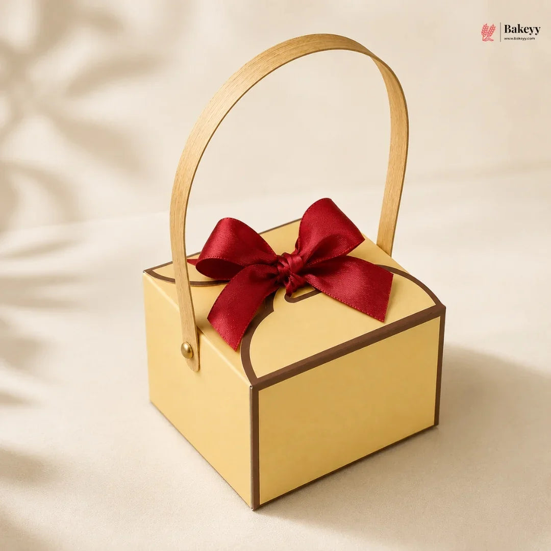 Yellow gift box with a red ribbon on a beige background