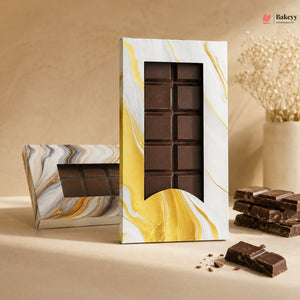 Chocolate bar in a decorative packaging with a marble design on a beige background.