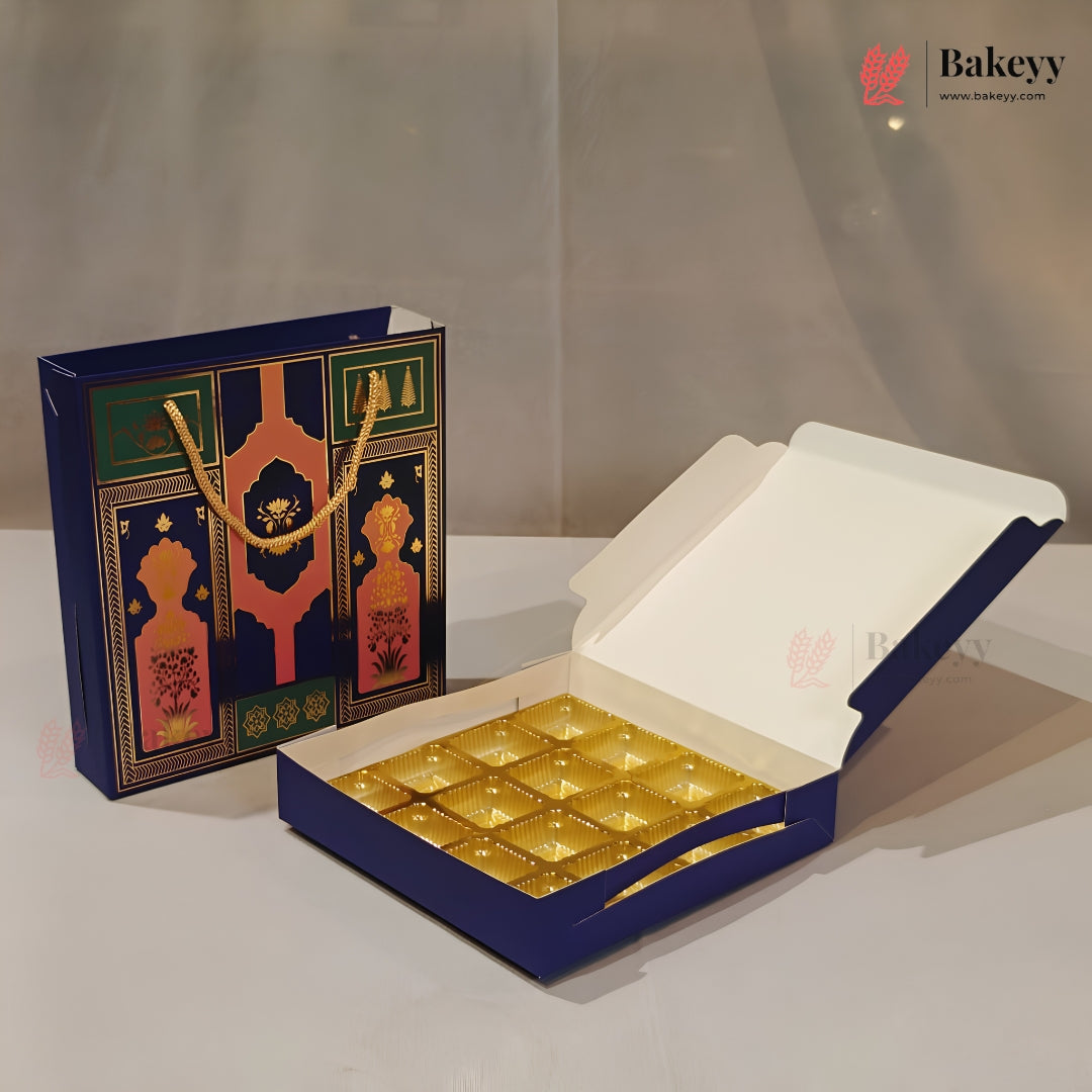 A blue and gold bakery gift set including an open box of individually wrapped pastries and a matching decorative gift bag, displayed on a neutral light gray background.