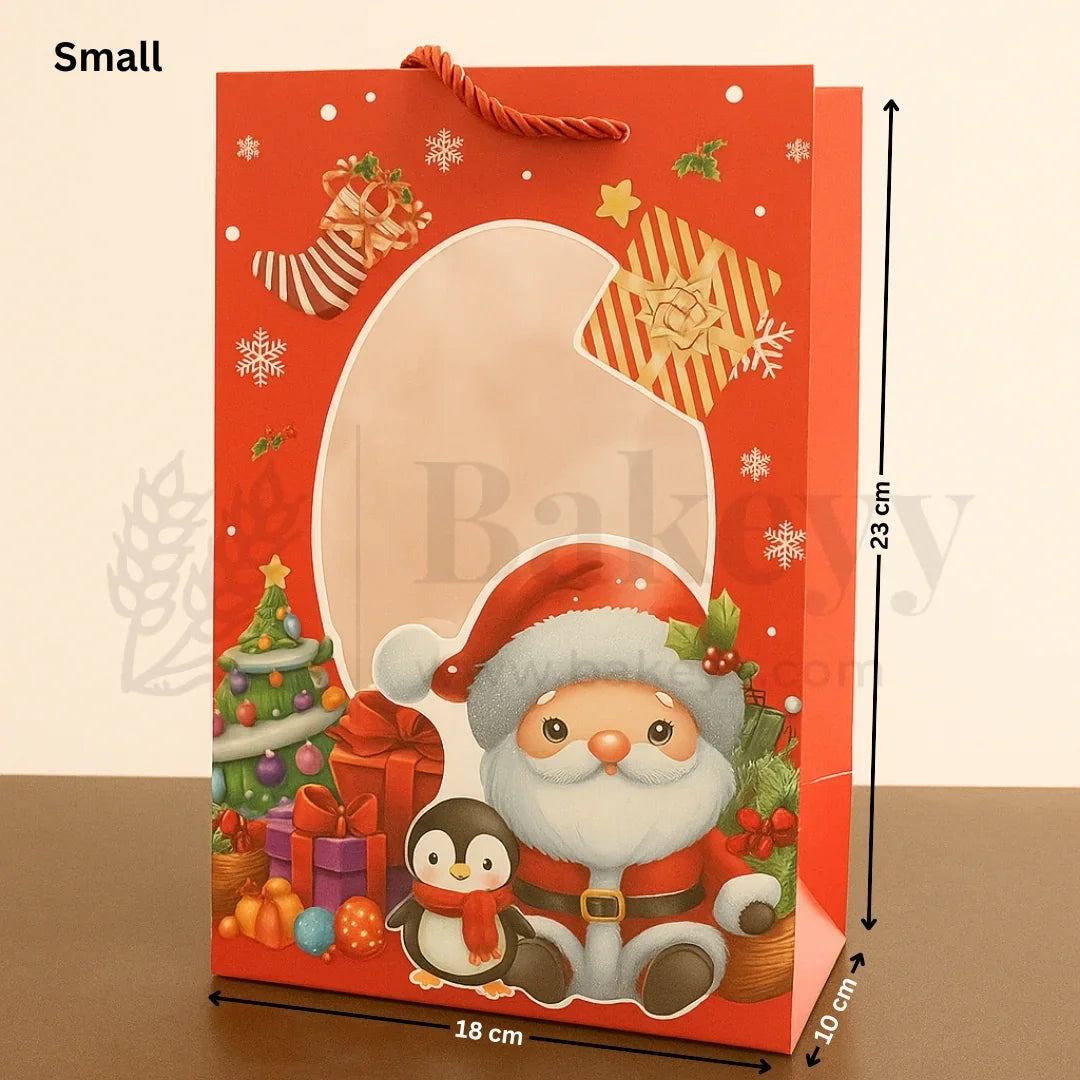 Small Christmas gift bag with Santa Claus and penguin design, featuring dimensions on a beige background.