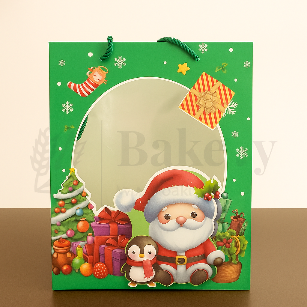 Green Christmas-themed gift bag with Santa Claus and penguin design on a beige background.
