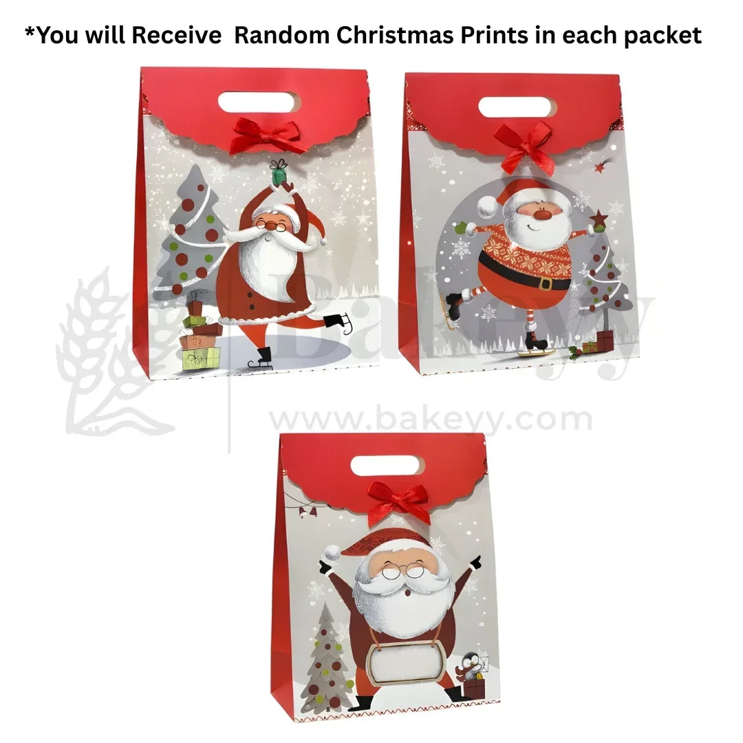 Three Christmas-themed gift bags with Santa Claus designs on a white background.
