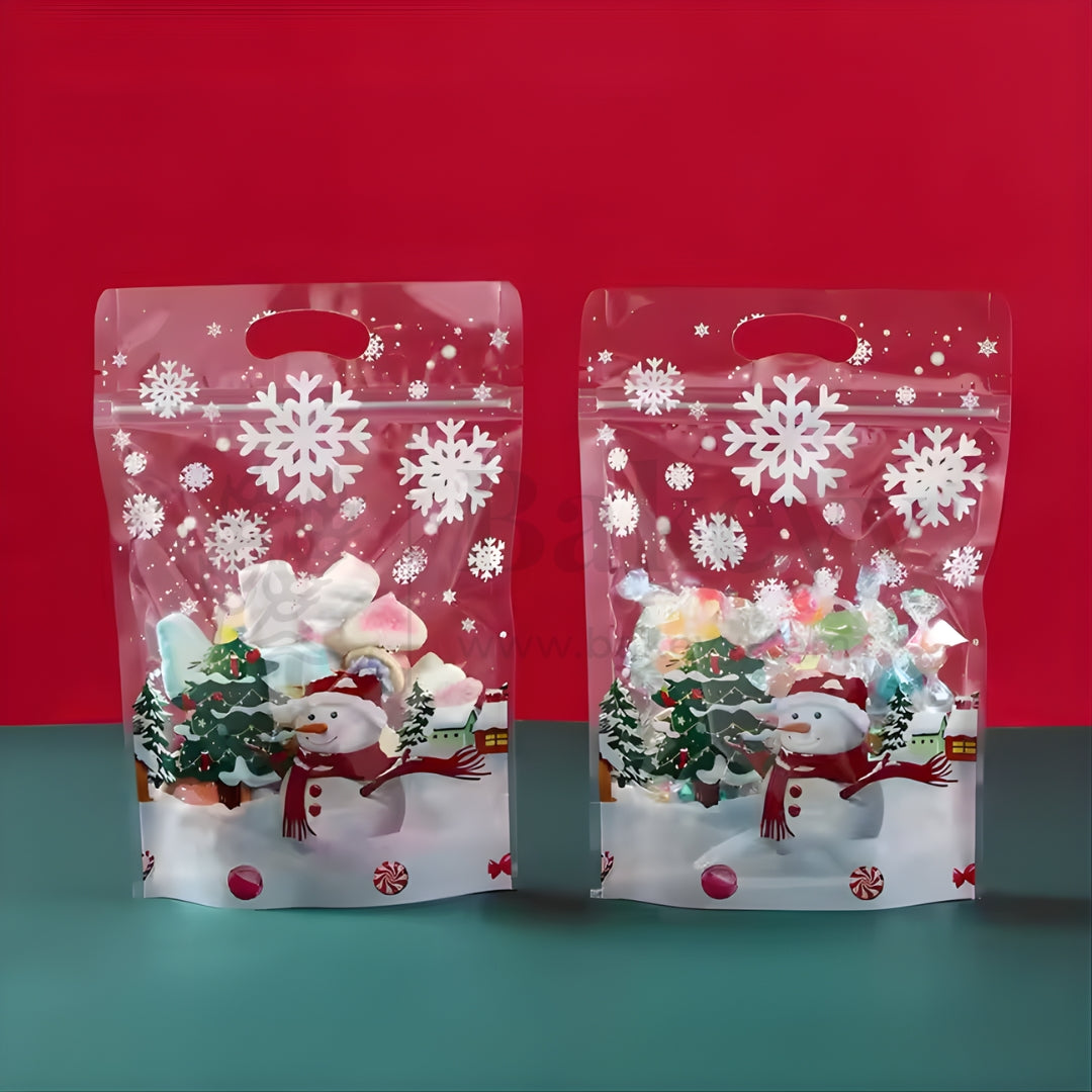 Two Christmas-themed clear bags with snowflakes and snowmen on a red and blue gradient background.