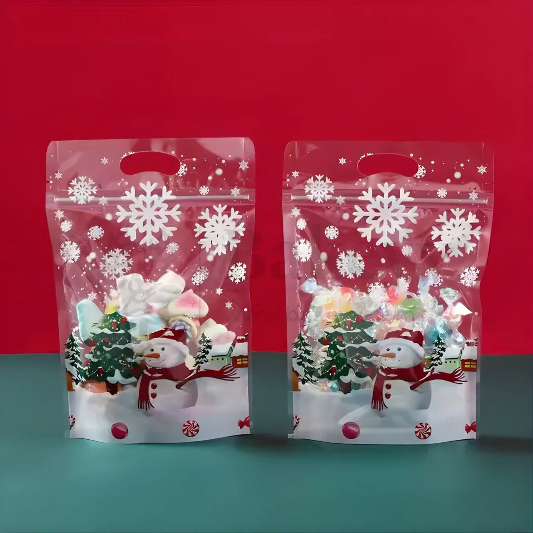Two Christmas-themed clear bags with snowflakes and snowmen on a red and blue gradient background.