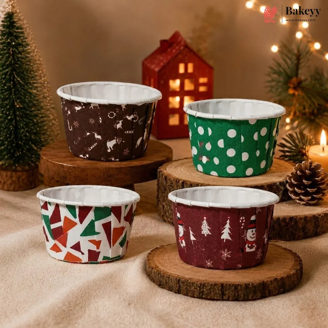 Four patterned cups on wooden stands with a festive background featuring lights and a small house.