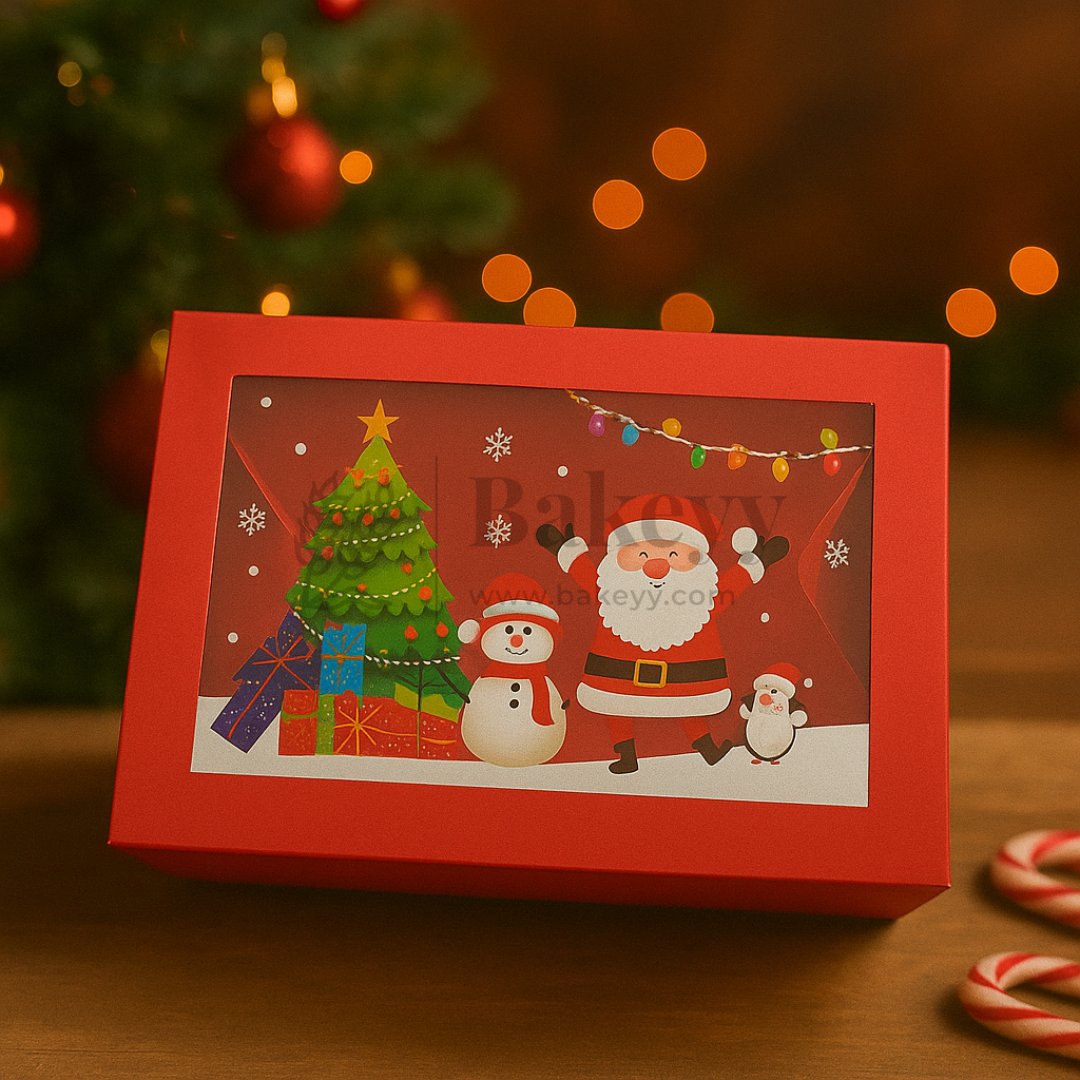 Red Christmas-themed gift box with Santa Claus, snowman, and tree design on a wooden surface.
