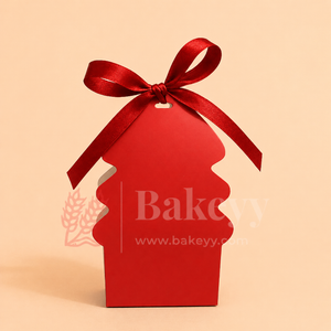 Red cupcake-shaped gift box with a red ribbon on a beige background, featuring the brand 'Bakeyy'.