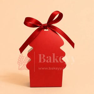 Red cupcake-shaped gift box with a red ribbon on a beige background, featuring the brand 'Bakeyy'.
