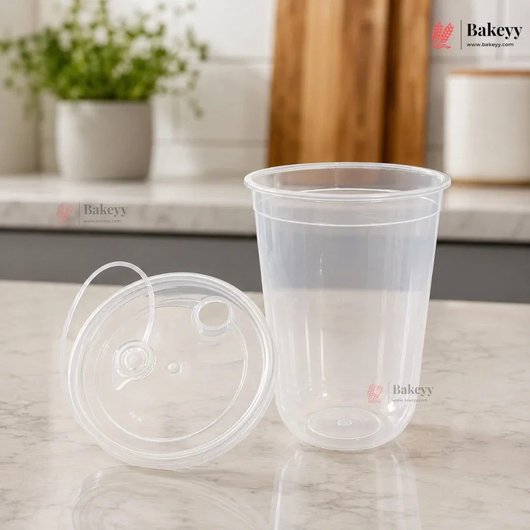 Clear plastic cup with lid on a marble surface, with 'Bakeyy' branding.