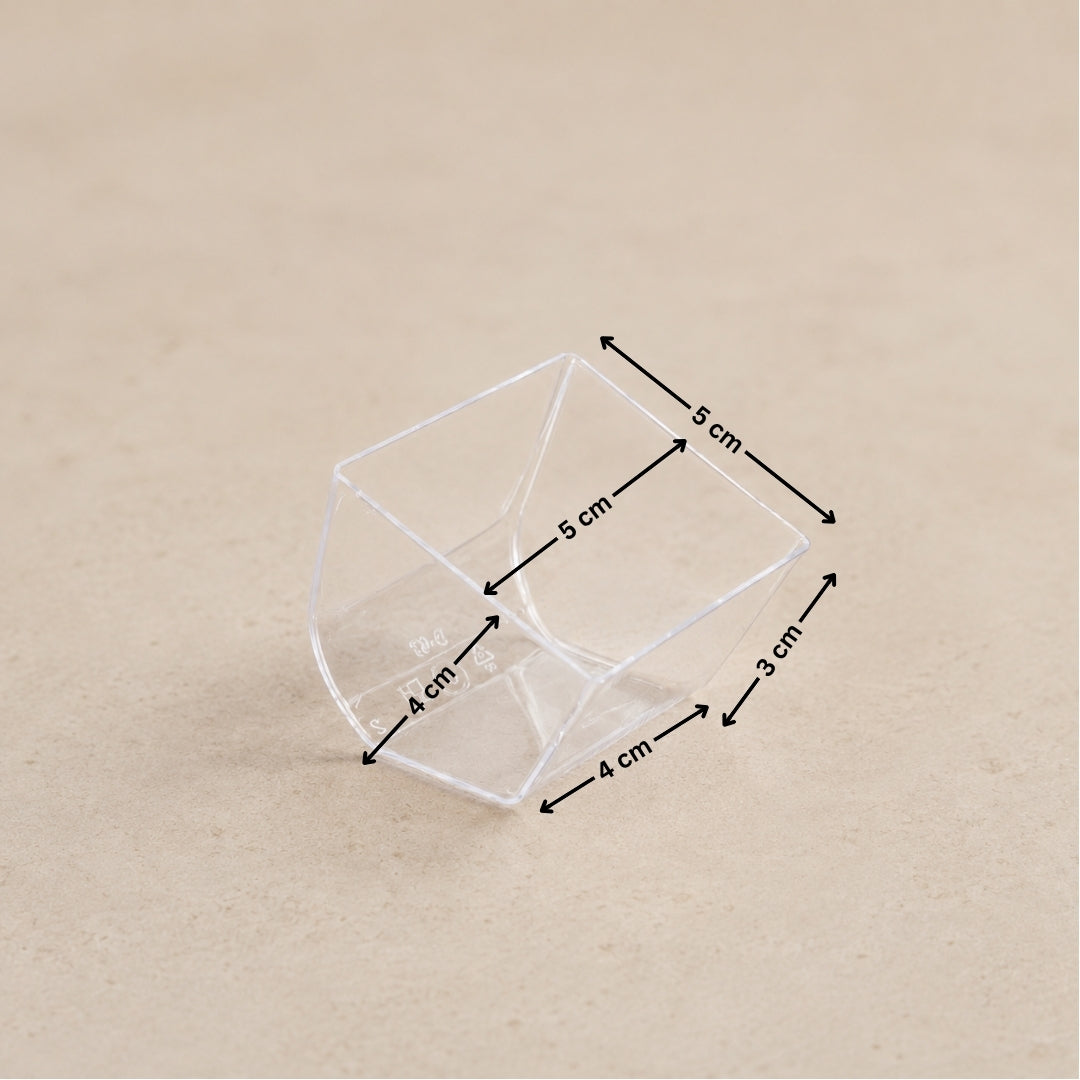 A clear plastic geometric container shown on a beige background with black dimension arrows and labels indicating measurements of 5 cm, 4 cm, and 3 cm.