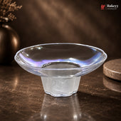Clear glass bowl on a dark surface with a blurred background