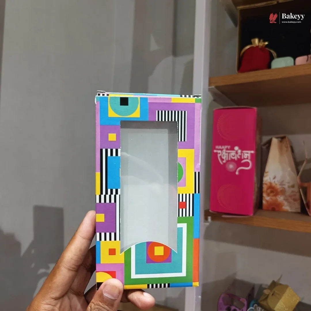 Colorful geometric patterned phone case held by a hand with a blurred background
