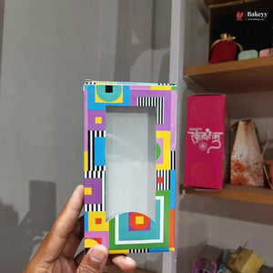 Colorful geometric patterned phone case held by a hand with a blurred background
