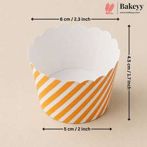 A scalloped paper cupcake liner with yellow and white diagonal stripes, shown with dimension arrows indicating a width of 5 cm (2 inches), height of 4.5 cm (1.