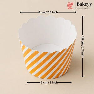 A scalloped paper cupcake liner with yellow and white diagonal stripes, shown with dimension arrows indicating a width of 5 cm (2 inches), height of 4.5 cm (1.