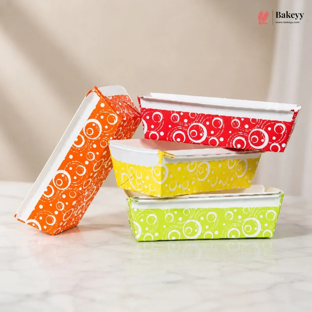 Colorful patterned food containers stacked on a light surface with 'Bakey' branding.
