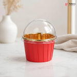 Red cup with gold interior and clear lid on a light surface, featuring the Bakey brand.