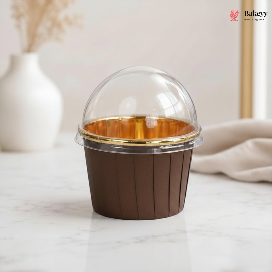 Brown dessert container with clear lid on a marble surface, featuring the Bakey brand.