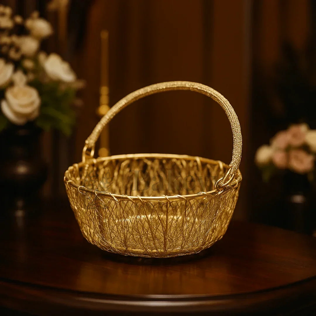 Elegant gold wire basket with handle on wooden table, ideal for hamper making from Bakeyy.com