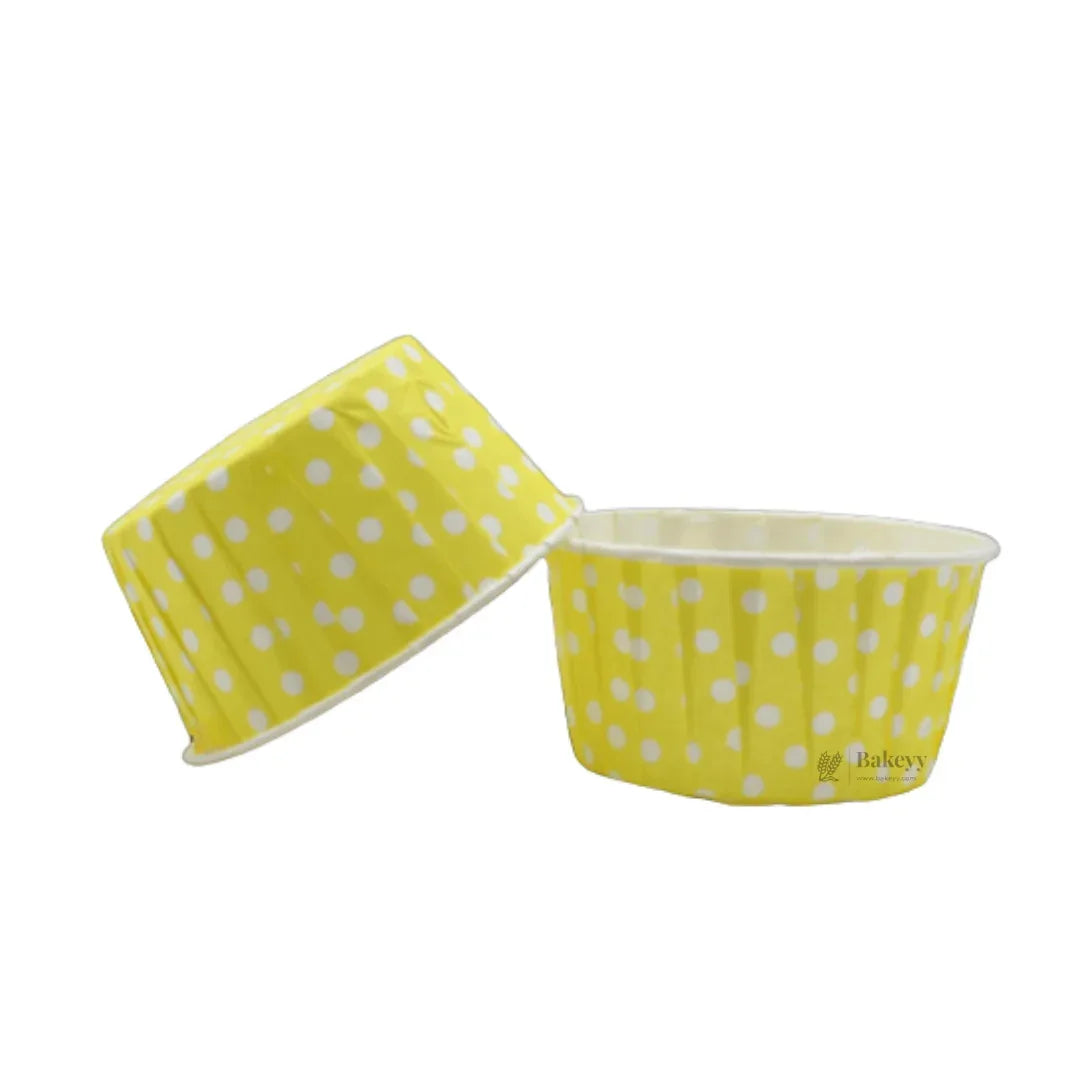 Yellow polka dot muffin cup baking liners from Bakeyy wholesale bakery supplies.
