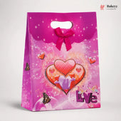 Pink gift bag with heart design and 'Love' text on a white background