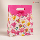 Decorative gift bag with colorful hearts and stars on a pink background, featuring the brand 'Bakeyv'.