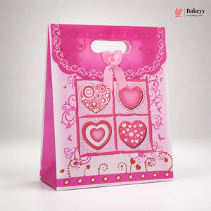 Pink gift bag with heart designs on a white background