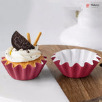 Red silicone cupcake mold with a decorated cupcake and white background