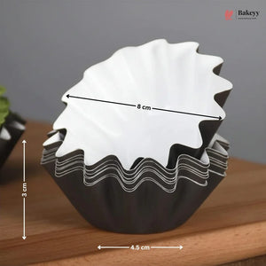 Black and white cupcake liner with measurements on a wooden surface