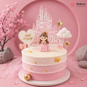 Pink and white cake with princess figurine and castle topper on a pink background