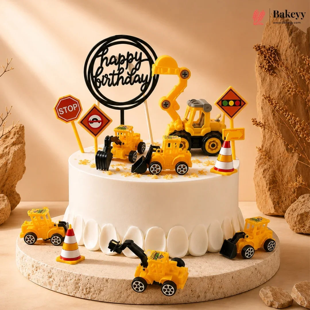 Birthday cake with construction-themed decorations including toy trucks and traffic signs on a beige background.