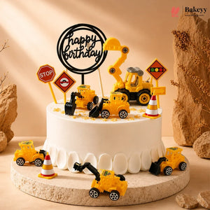 Birthday cake with construction-themed decorations including toy trucks and traffic signs on a beige background.
