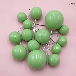 Green spherical objects on a pink background