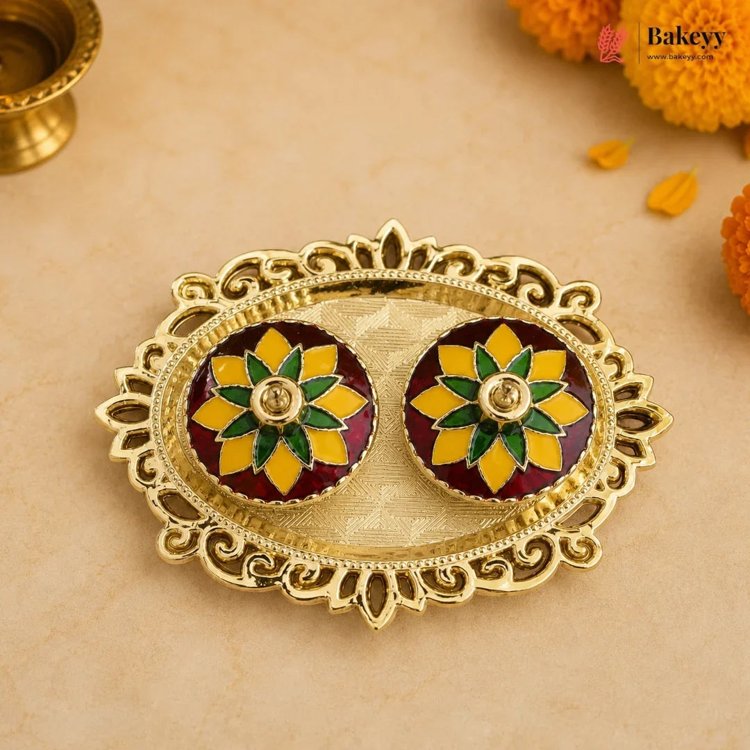 Decorative gold plate with floral designs on a beige background