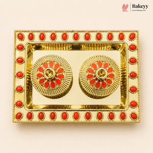 Decorative gold tray with red stones on a beige background, featuring the Bakeyy brand.