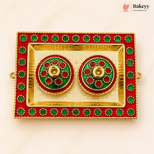 Decorative earrings in a red and gold box with green accents, branded 'Bakeyy'.