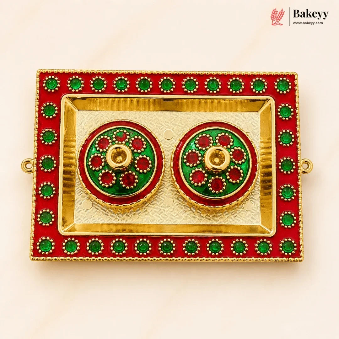 Decorative earrings in a red and gold box with green accents, branded 'Bakeyy'.