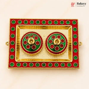 Decorative earrings in a red and gold box with green accents, branded 'Bakeyy'.