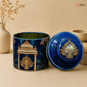 Decorative blue ceramic container with intricate gold patterns on a beige background