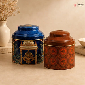 Two decorative tea canisters, one blue and one brown, on a beige surface with a neutral background.