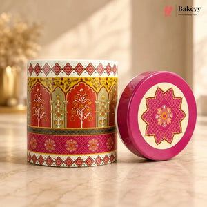 Decorative tin can with a pink lid featuring intricate patterns on a wooden surface.