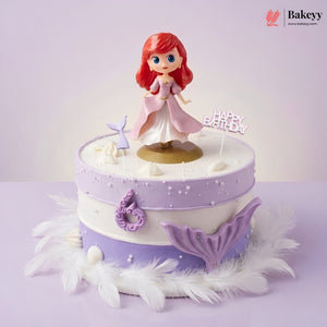 Decorative cake with a mermaid figurine and 'Happy Birthday' topper on a light purple background.