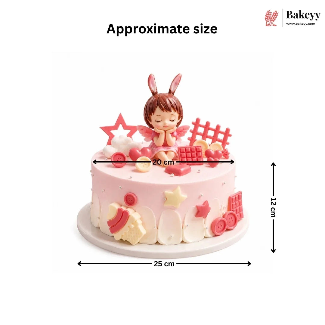 Decorative cake with fairy figurine and measurements on a white background