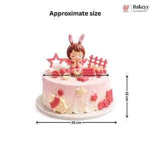 Decorative cake with fairy figurine and measurements on a white background