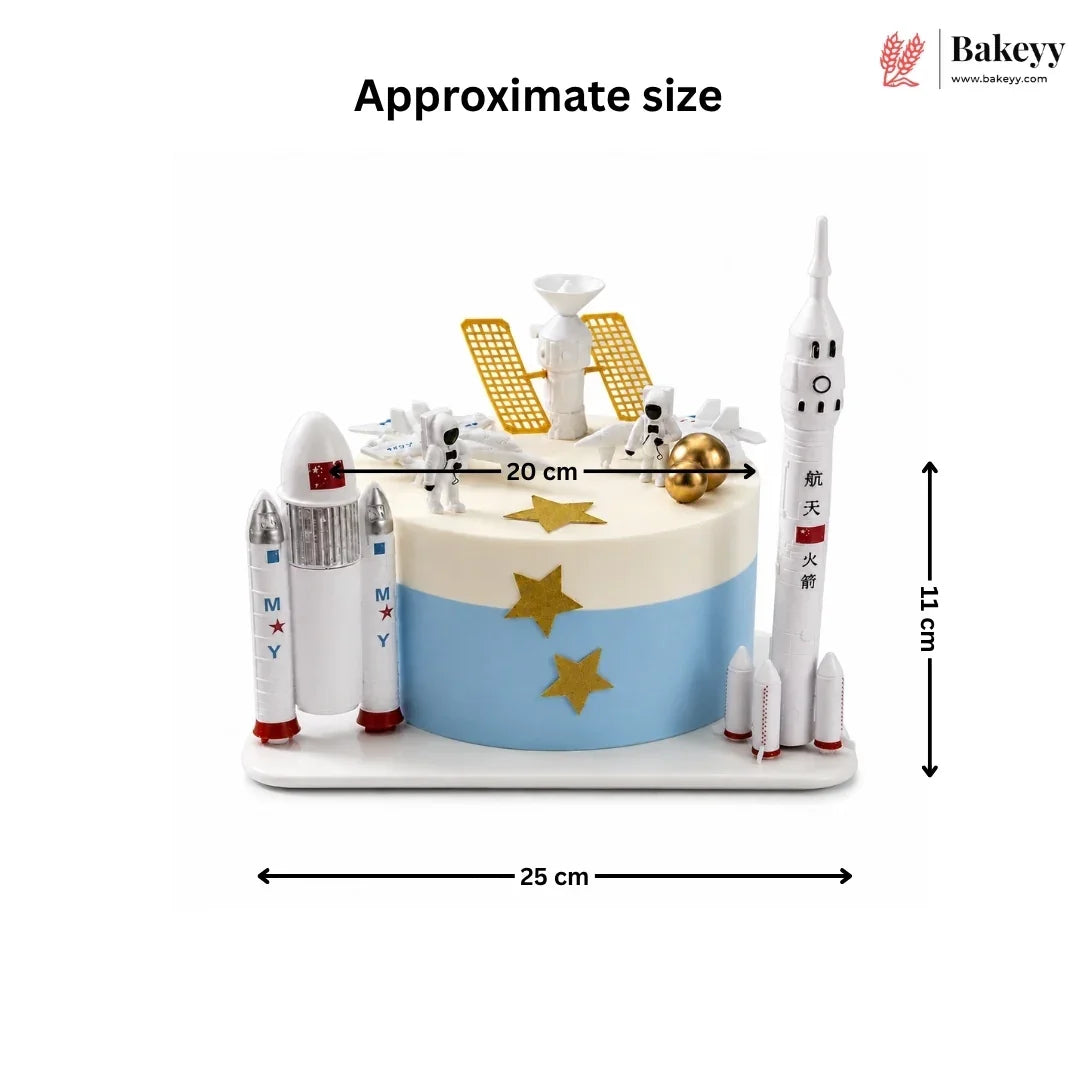 Space-themed cake with rocket models and measurements on a white background