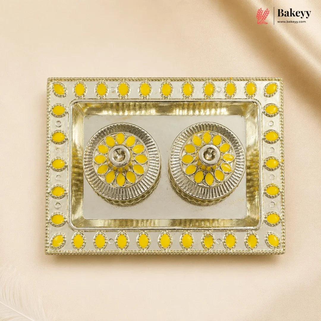 Decorative tray with yellow and silver design on a beige background