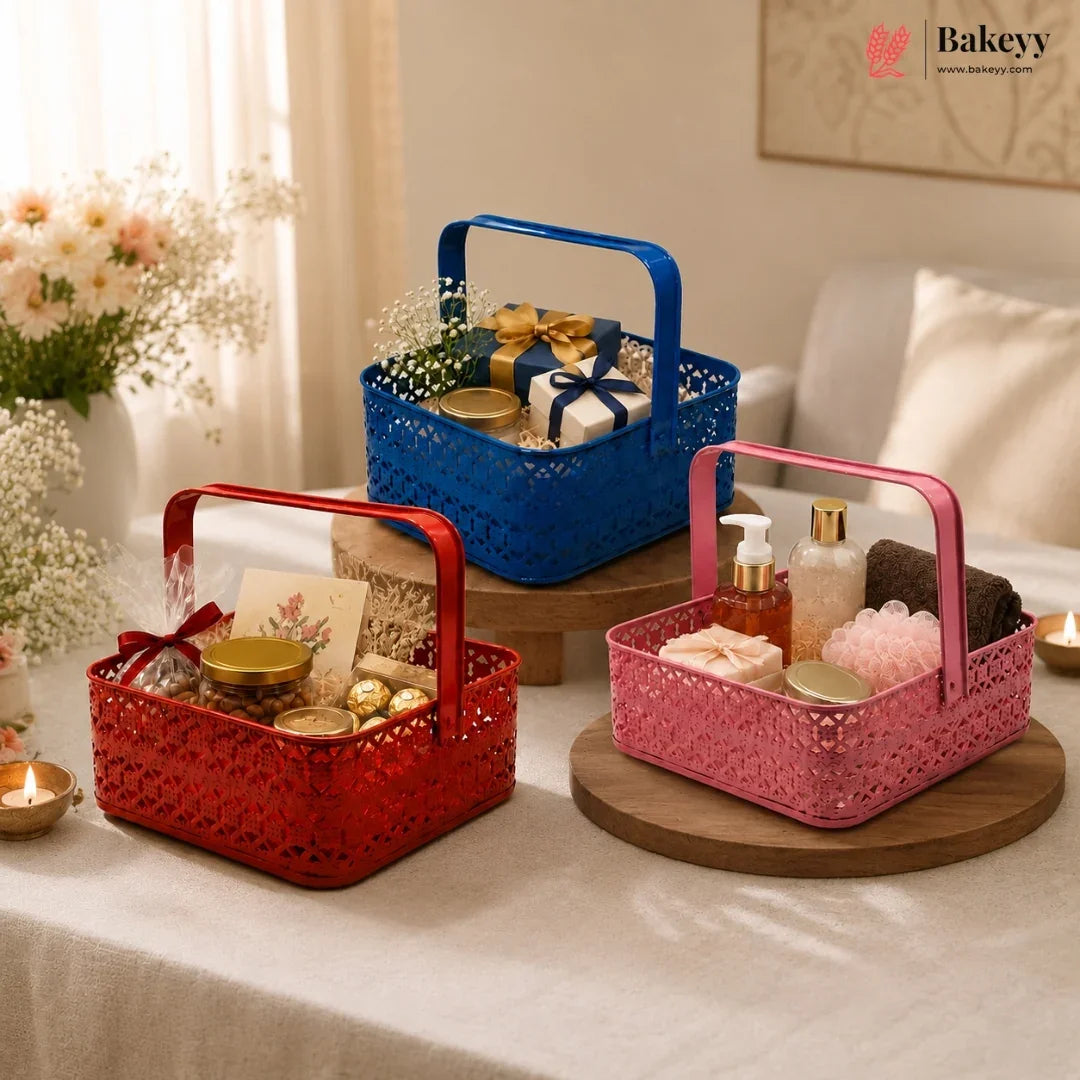 Three decorative baskets in red, blue, and pink on a table with various items.