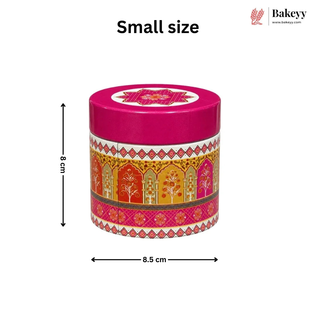 A small round decorative tin with a bright pink lid and a multicolor patterned body, shown on a white background with dimension arrows labeled 8 cm height and 8 cm width. The text 'Small size' appears above, and the Bakeyy logo is in the top right.