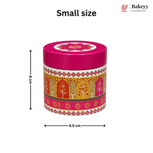 A small round decorative tin with a bright pink lid and a multicolor patterned body, shown on a white background with dimension arrows labeled 8 cm height and 8 cm width. The text 'Small size' appears above, and the Bakeyy logo is in the top right.