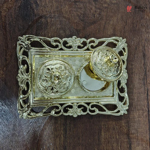 Decorative gold doorknob on a wooden door